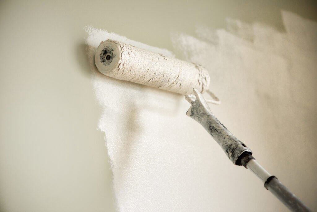 Professional wall painting with a roller in progress in Inland Empire.